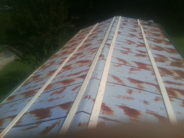 Rusted metal roof panels with new wood purlins before replacement — Storm Damage Roof Repair in Servia by Roofing Brothers